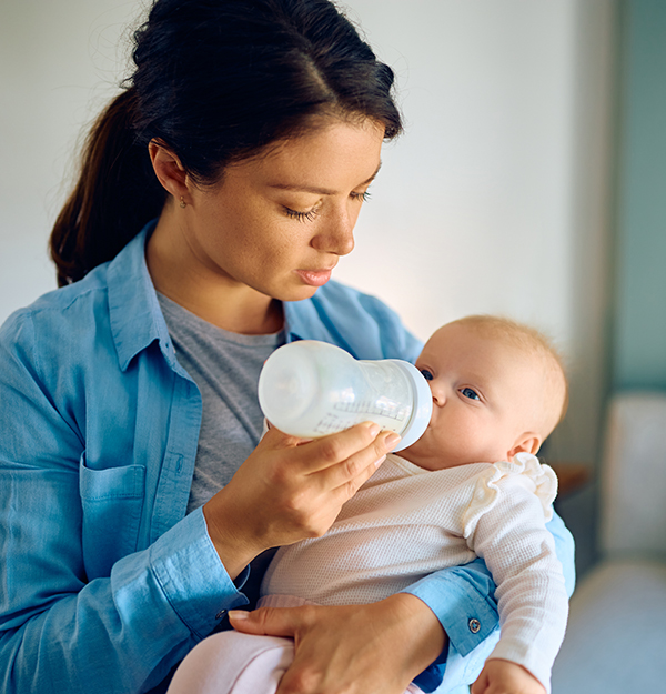 mother using baby bottle