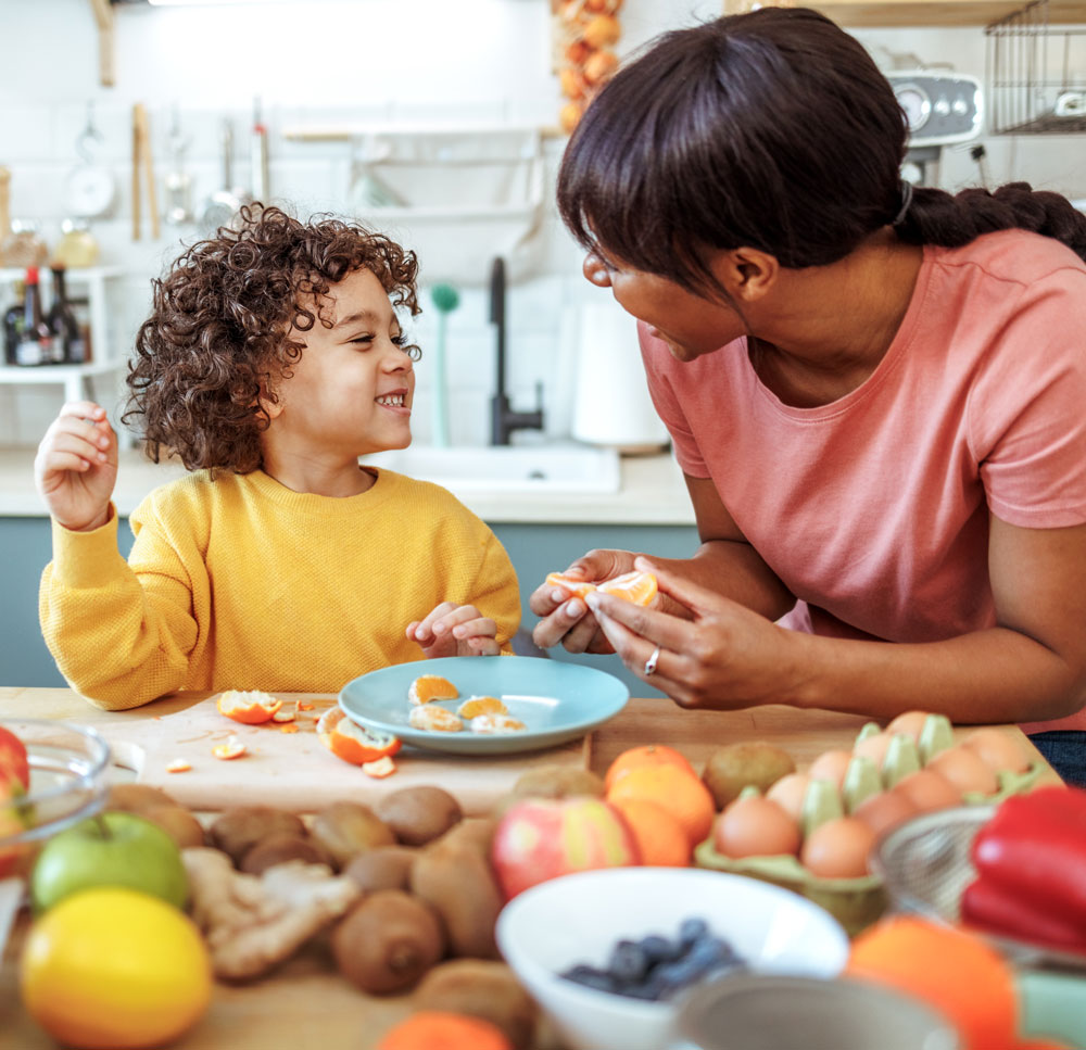 woman and child enjoy a meal at a table