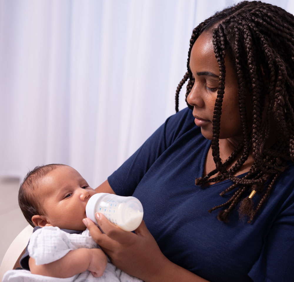 Baby drinking from feeding bottle