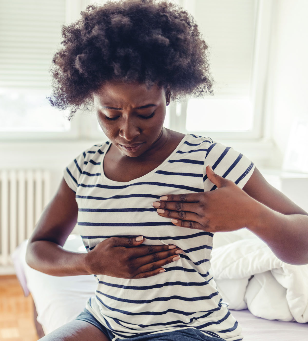 Woman examining her breast at home