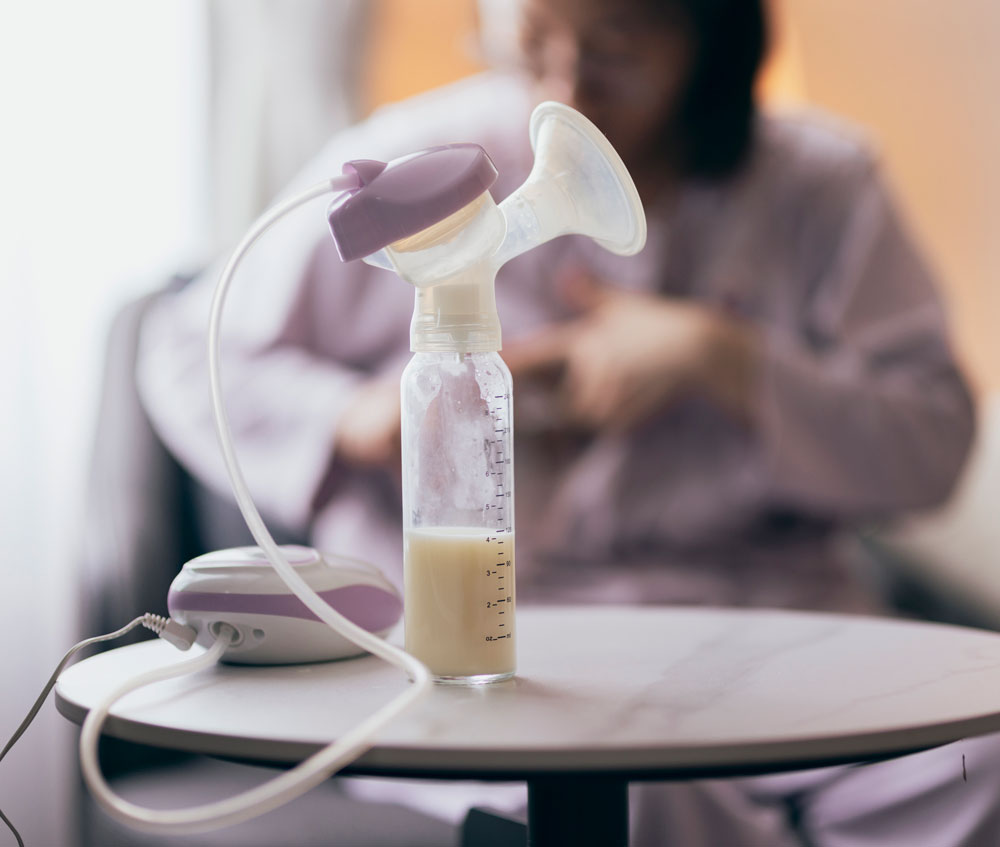 Breast pump with milk bottle on round table