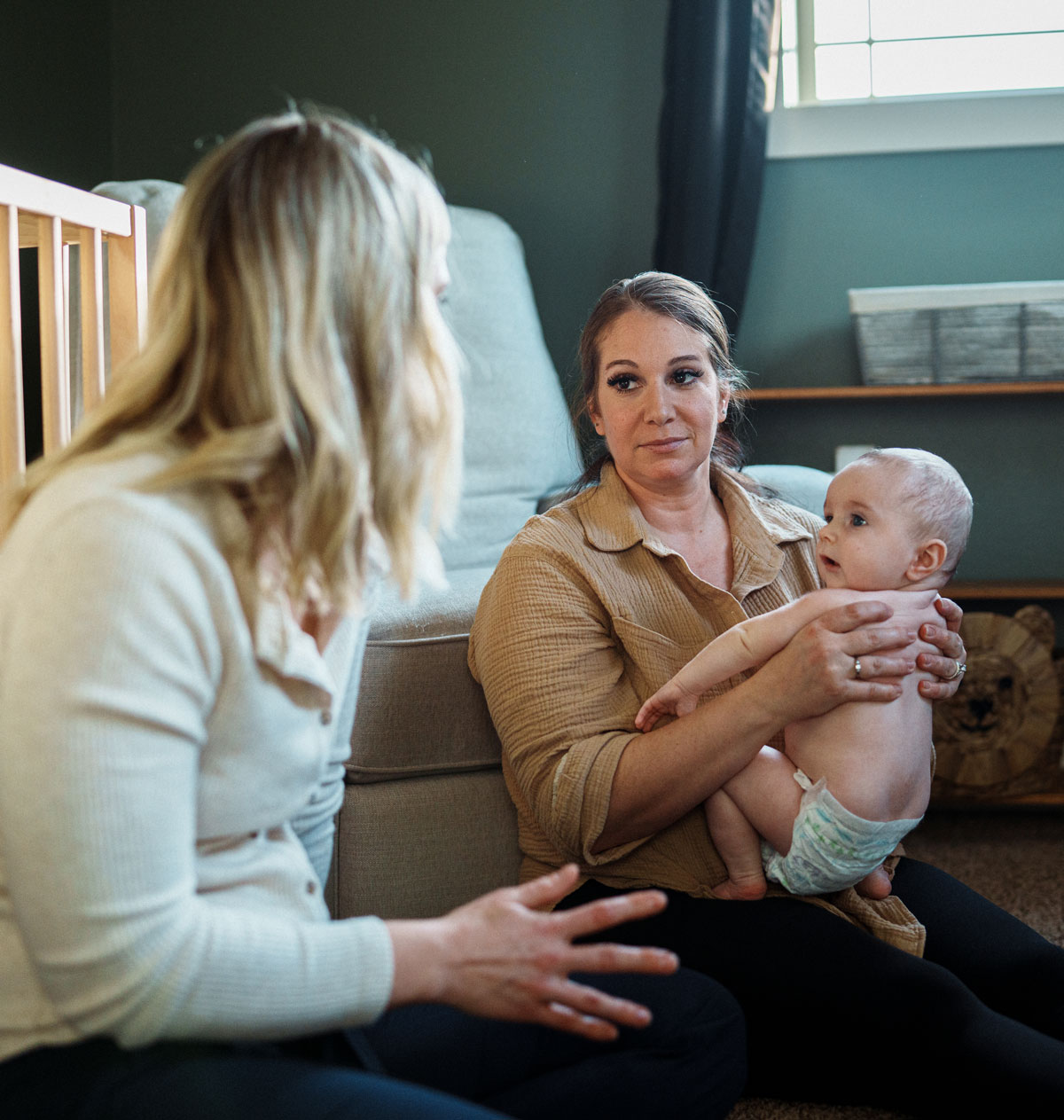 Lactation counselor discussing with mother holding baby