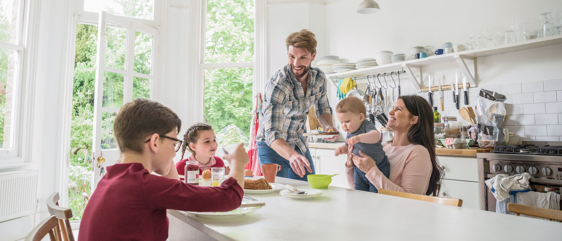 Family enjoying breakfast together in bright kitchen