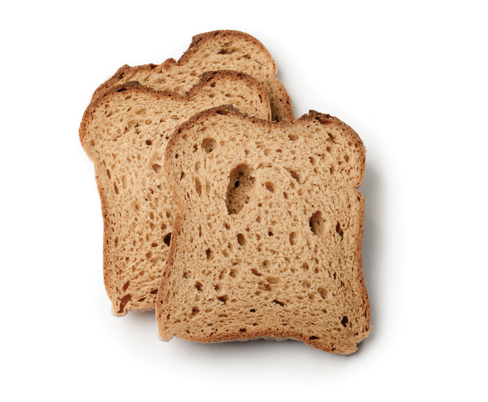 Slices of whole-grain bread on white background